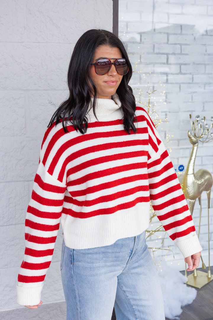 Women's red and cream striped knit cropped turtleneck sweater by hyfve showing up close slight side view