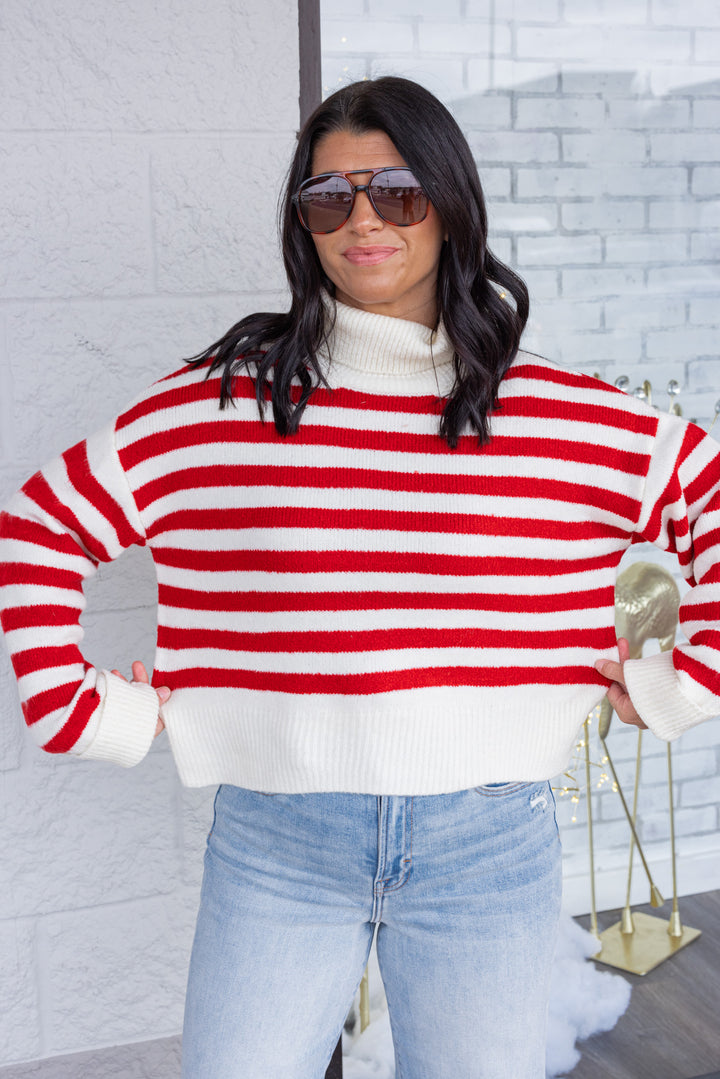 Women's red and cream striped knit cropped turtleneck sweater by hyfve showing true to size fit