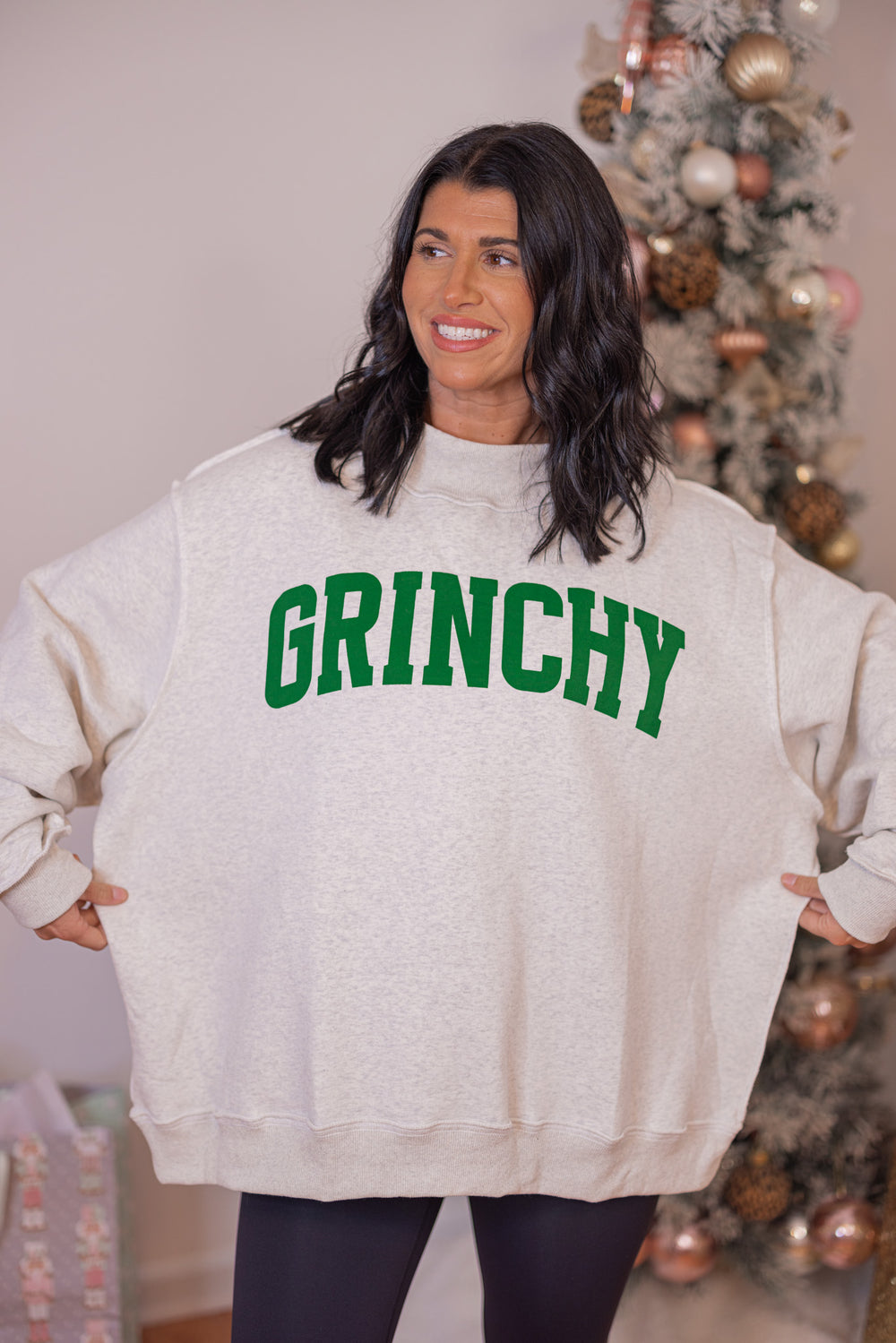 Women&#39;s reversible sweatshirt with &quot;Grinchy&quot; on grey or &quot;Naughty&quot; on white by BucketList showing oversized fit
