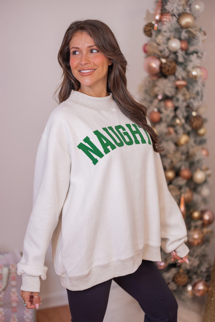 Women's reversible sweatshirt with "Grinchy" on grey or "Naughty" on white by BucketList showing up close angled view