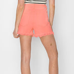 risen coral colored denim cut off shorts with raw hem line