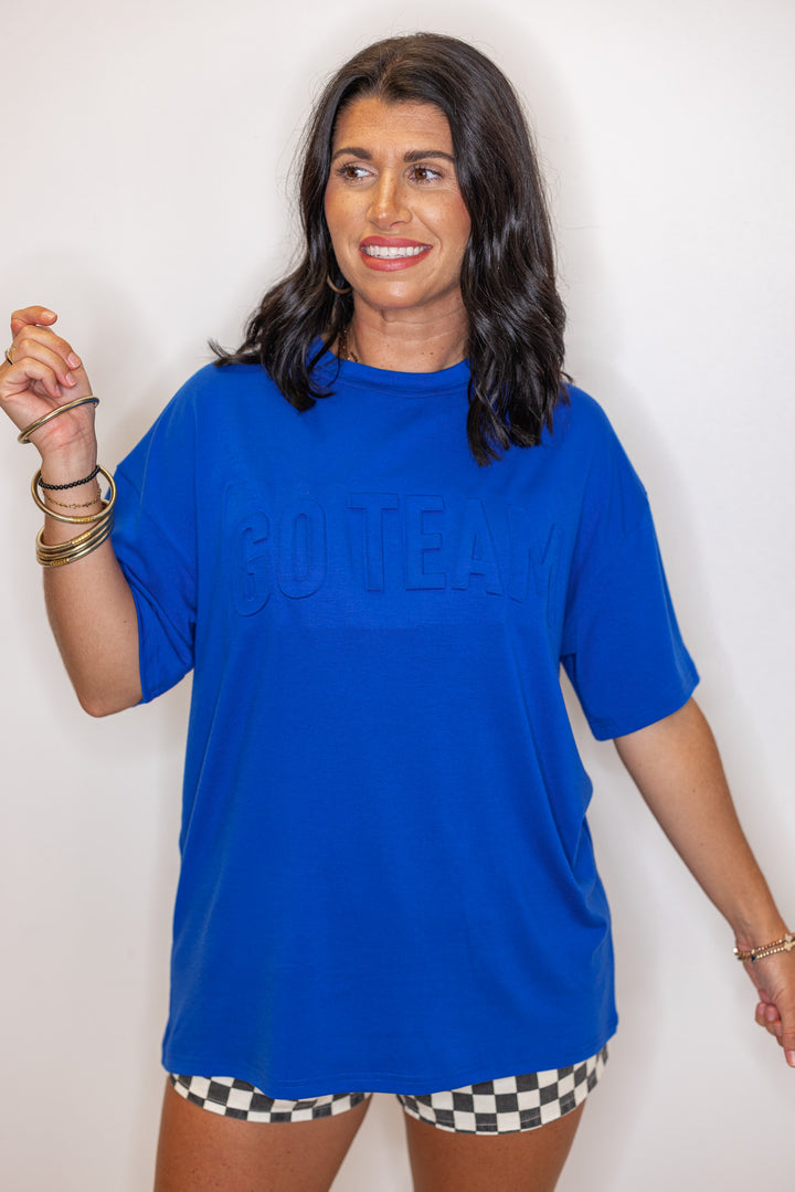 Women's royal blue lightweight top with embossed 'Go Team' in center by Jess Lea
