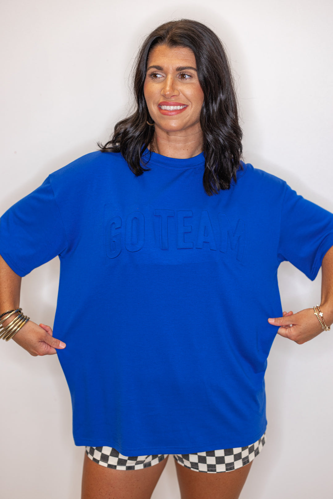 Women's royal blue lightweight top with embossed 'Go Team' in center by Jess Lea showing relaxed fit