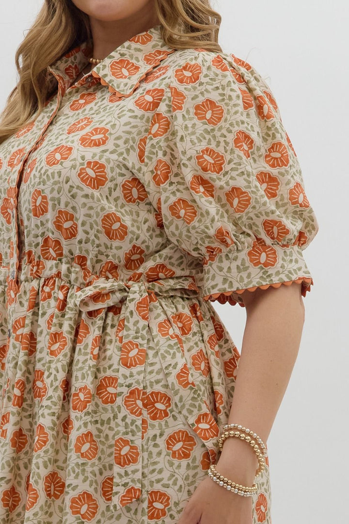 Women's plus size cream button front midi dress with rust floral print by Entro showing adjustable waistband side ties