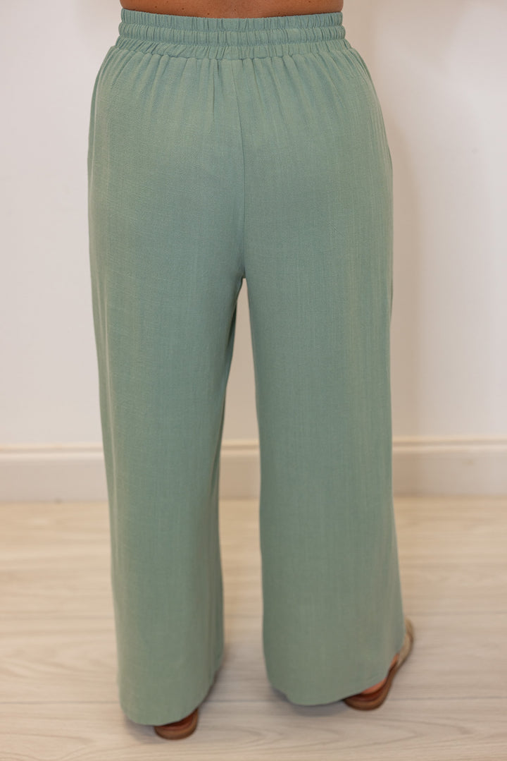 Women's sage green linen bow tie top and elastic waist wide leg pants set by Jodifl showing up close back view of bottoms