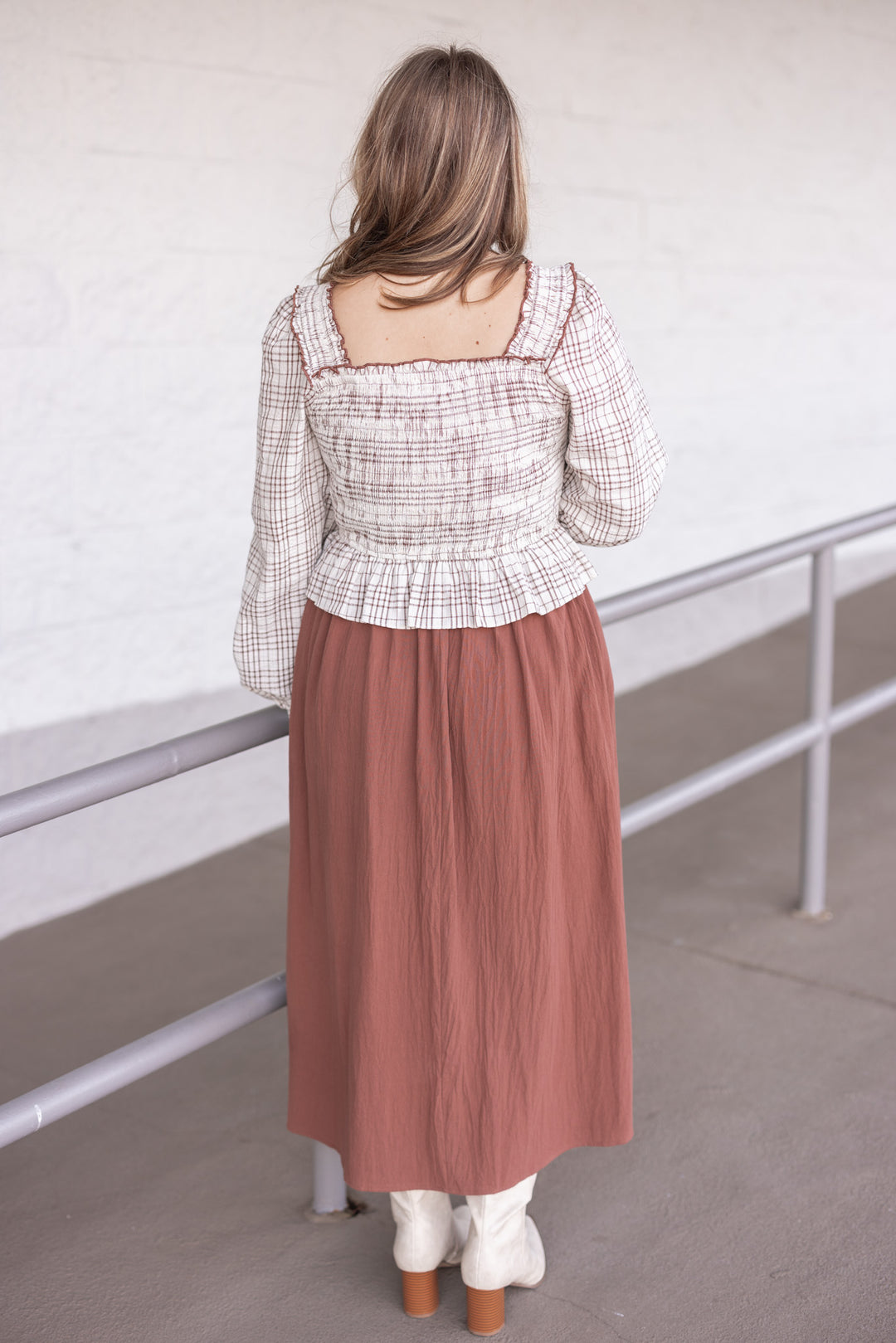 Women's ruffle detailed midi dress with smocked plaid top and solid brown skirt by In February showing back view