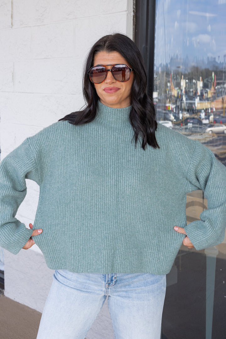 Women's pistachio green ribbed knit sweater by Wishlist showing true to size fit