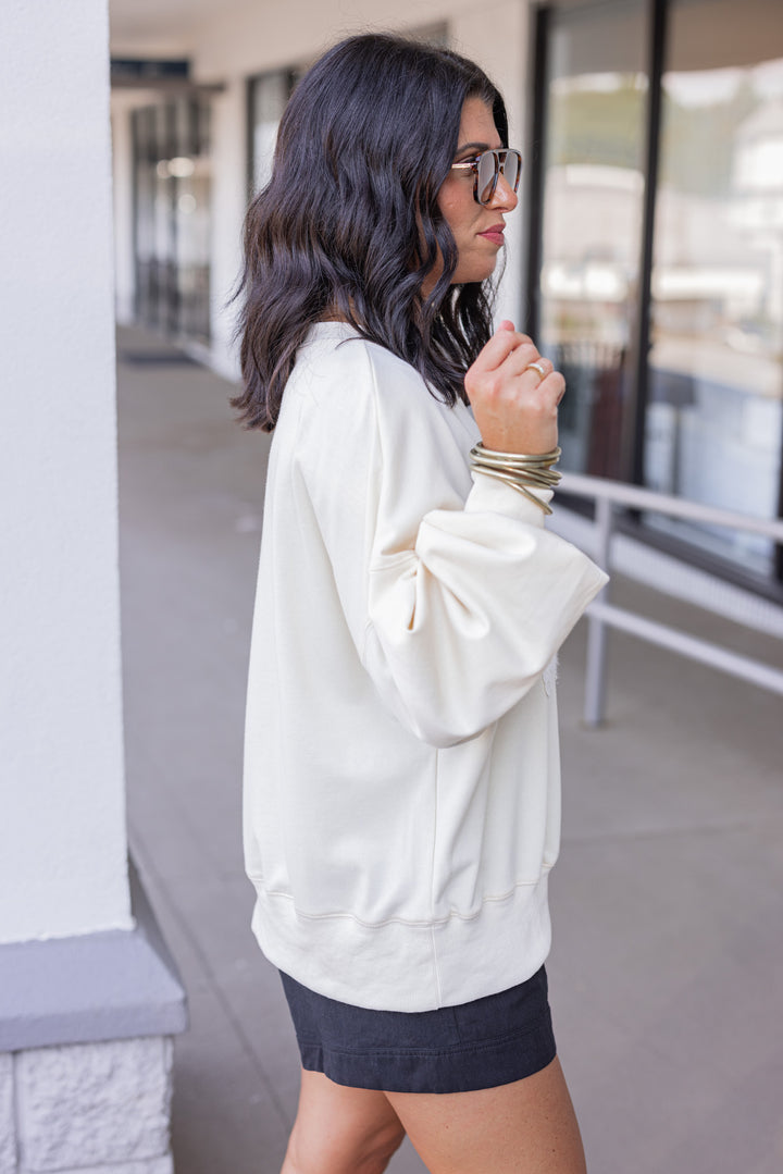 Women's cream sweatshirt with "Spooky" in lace ghosts and black checkered print by Peach Love California showing up close side view