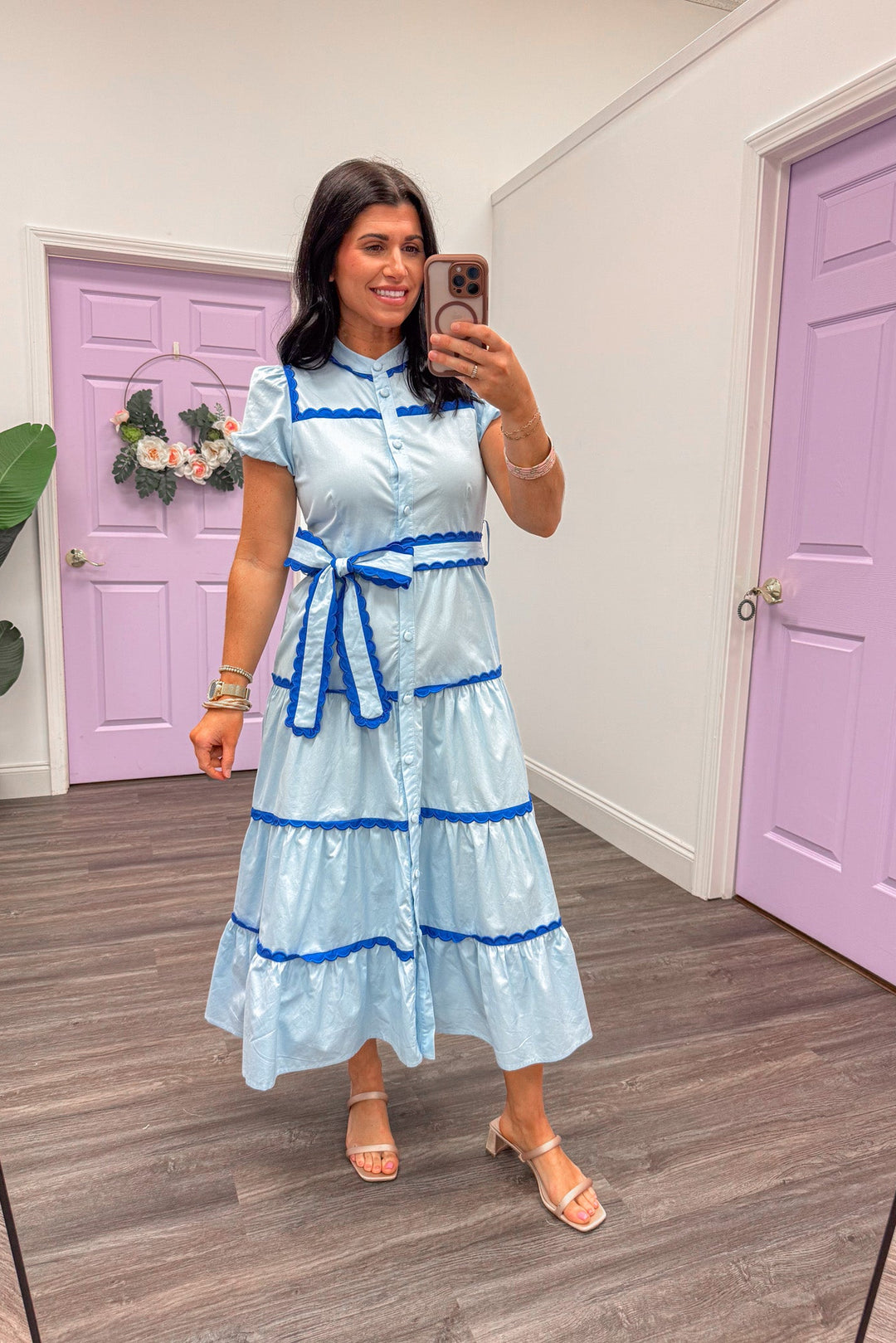 Women's light blue tiered midi dress with dark blue scalloped piping trim, perfect for teachers