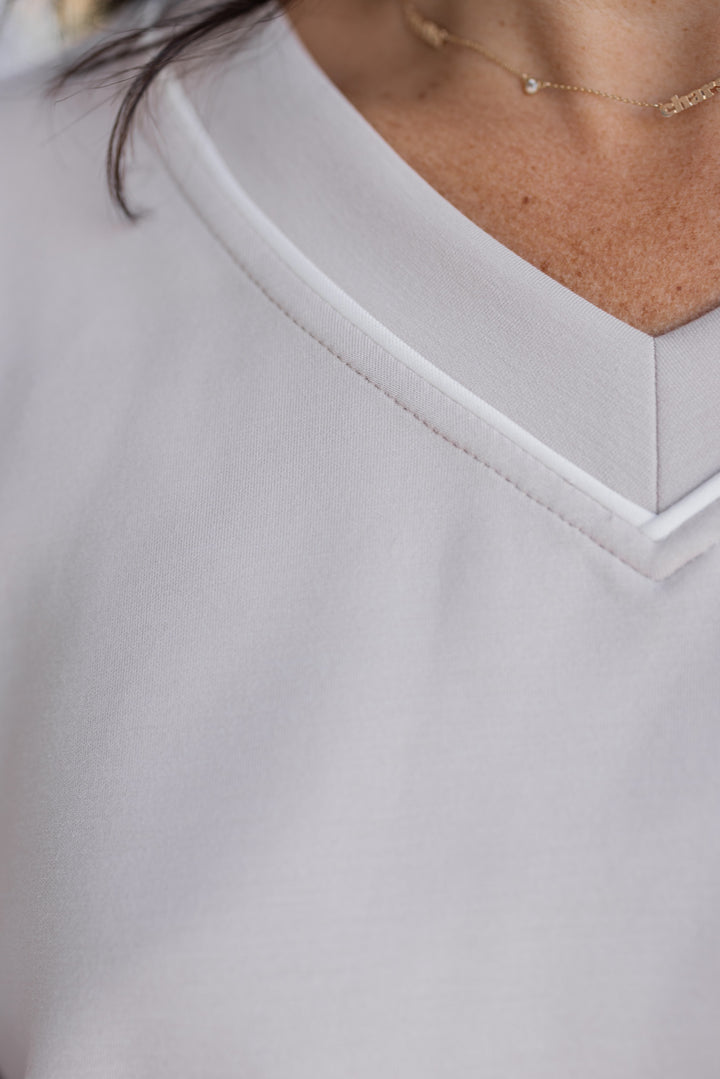 Women's mocha and cream scuba knit top by Rae Mode showing ivory striped piping on neckline