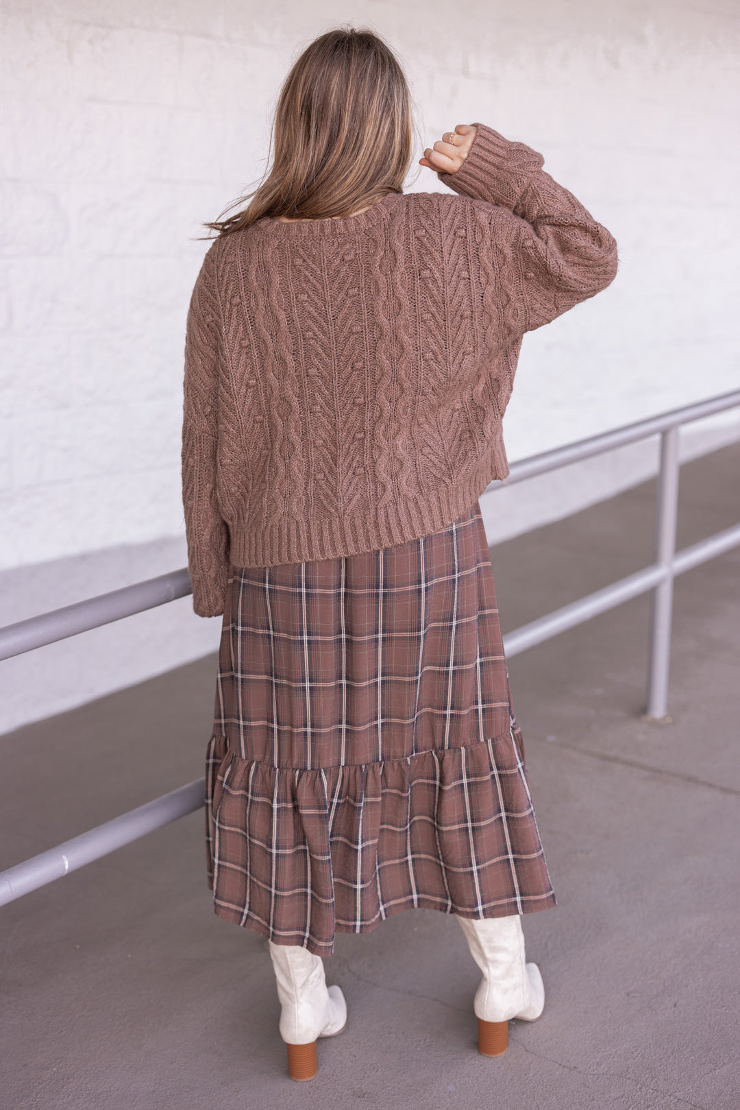 Women's mocha brown cable knit sweater cardigan with black bow tie closure by Blu Pepper showing back view