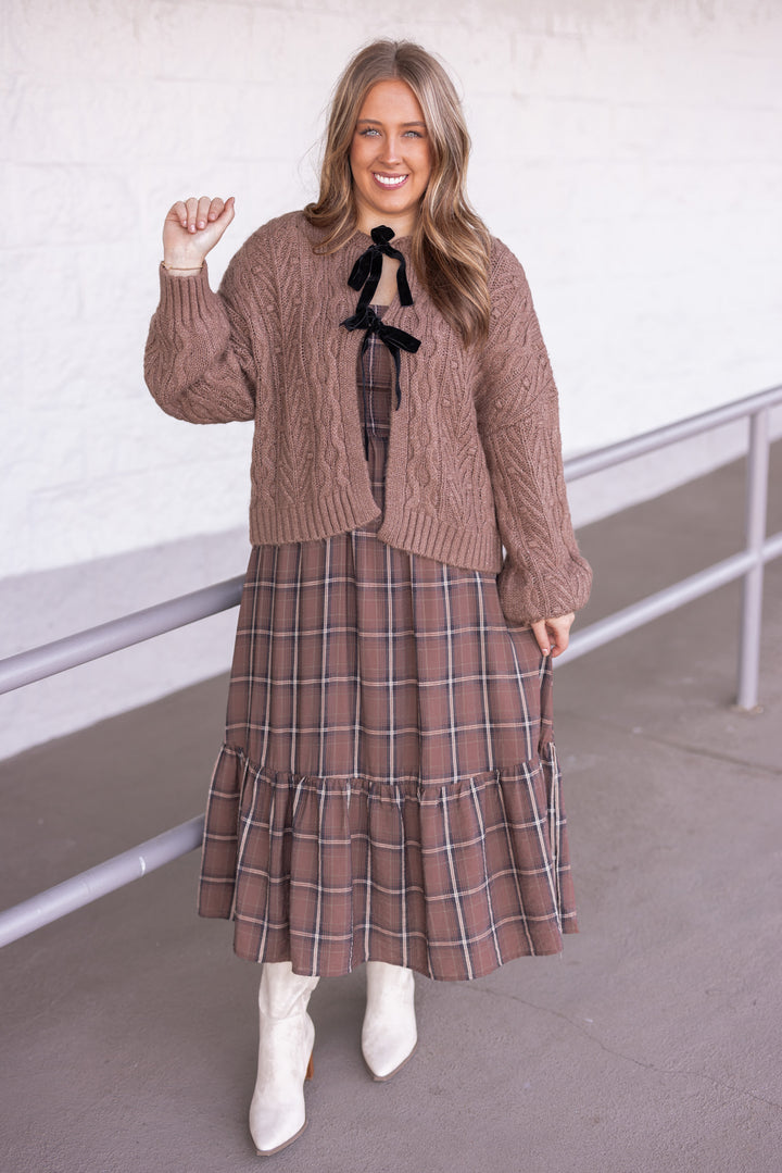 Women's brown plaid midi dress with smocked bodice by Blu Pepper shown with sweater cardigan