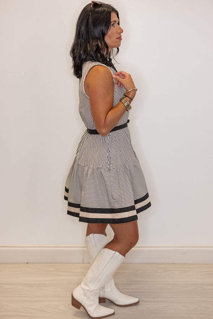 Womens black and cream striped button front dress with belted waist by Entro showing full side view