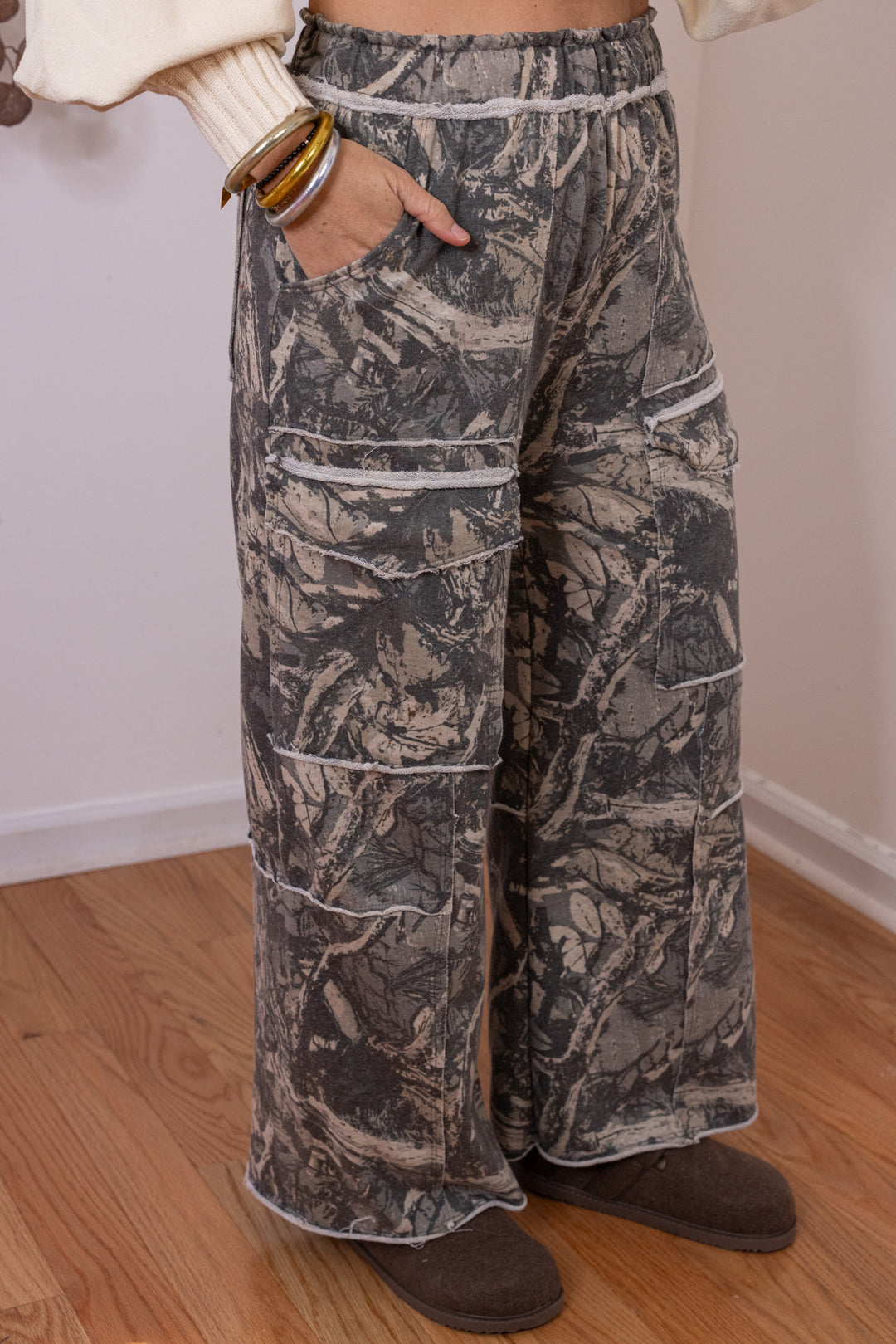 Women's washed hunter green terry knit wide leg cargo pants in tree camo print by J. Her showing slight side view