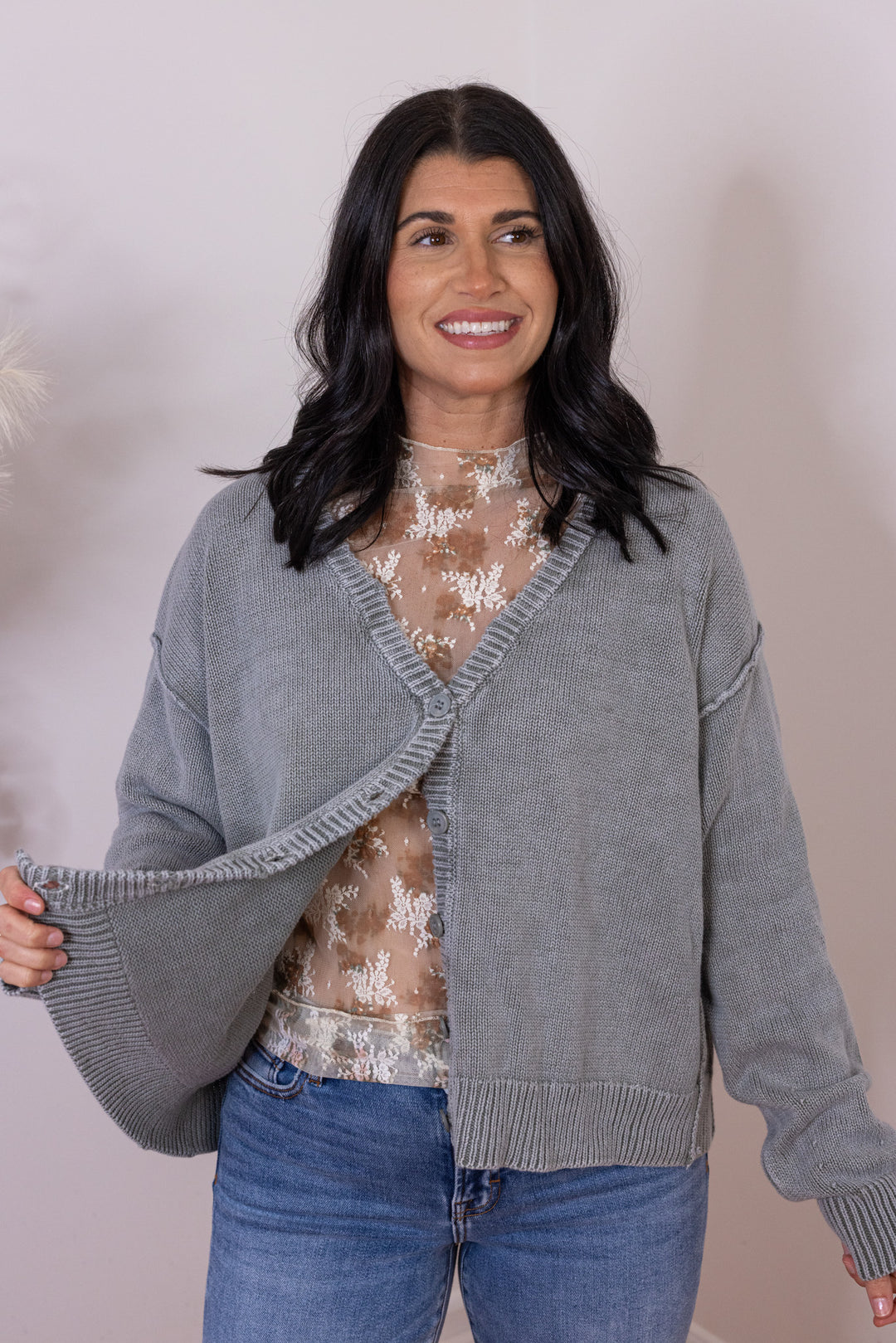 Women's washed olive green button front sweater knit cardigan showing button front closures