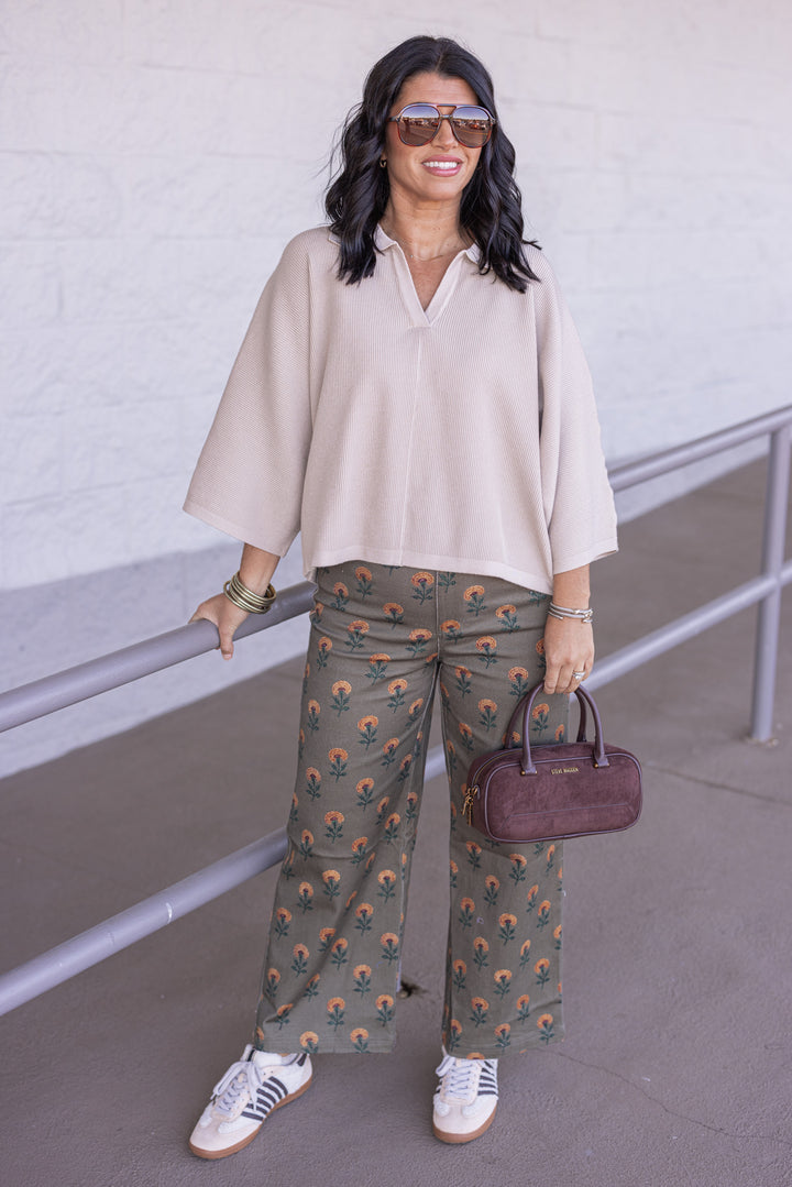 Women's light beige ribbed knit top with a collar by Entro showing full front view