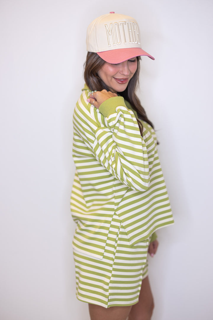 Women's ribbed knit top in matcha green and cream stripes by Entro showing side slits