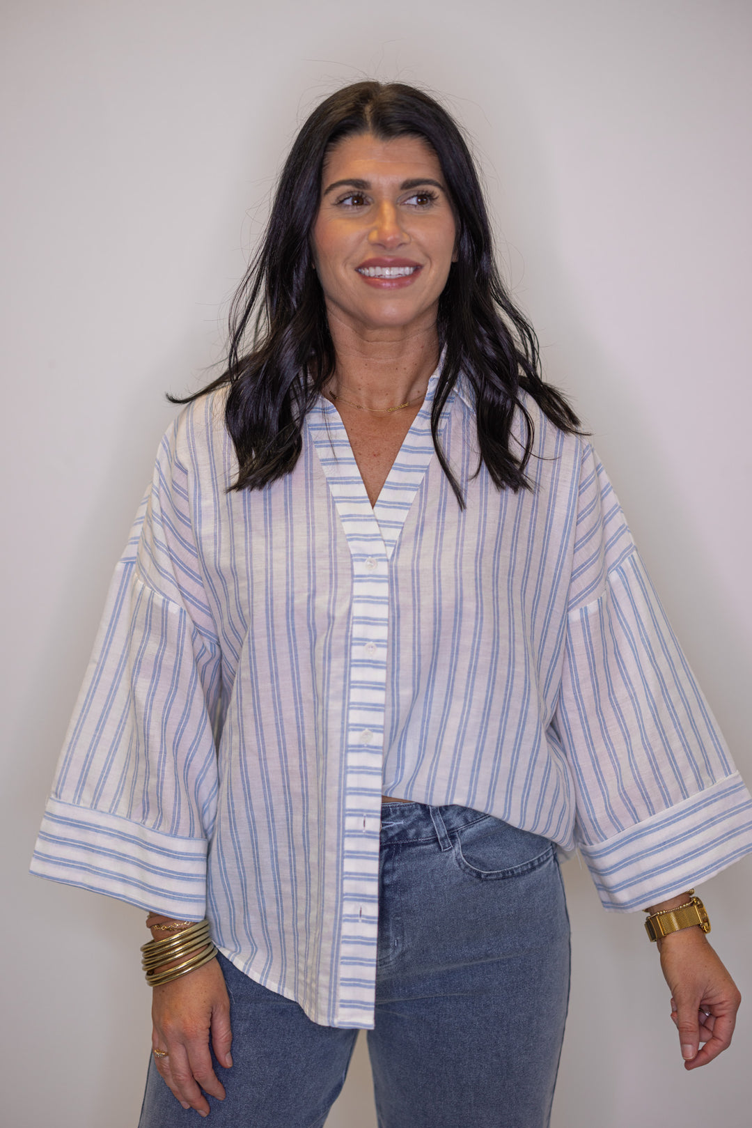 Women's light blue and cream striped button down top, great for warmer weather