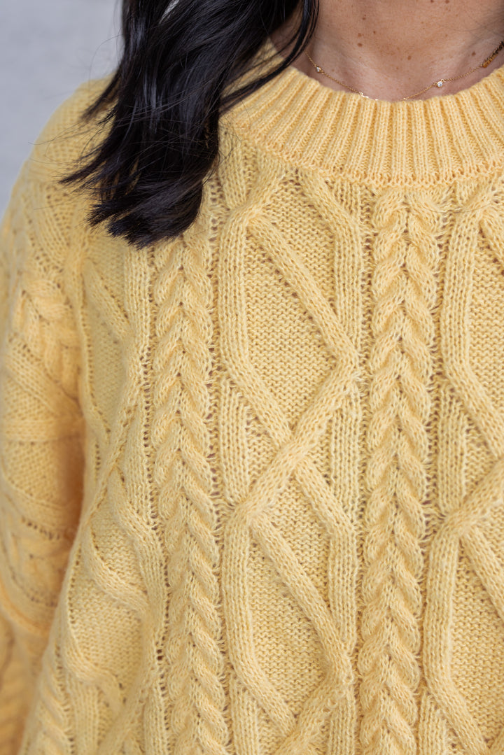 Women's yellow cable knit relaxed, boxy fit sweater by GeeGee showing up close look at cable knit fabric