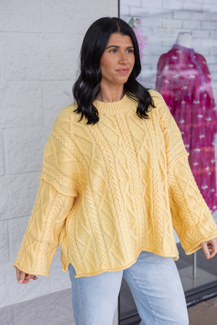 Women's yellow cable knit relaxed, boxy fit sweater by GeeGee showing up close side view
