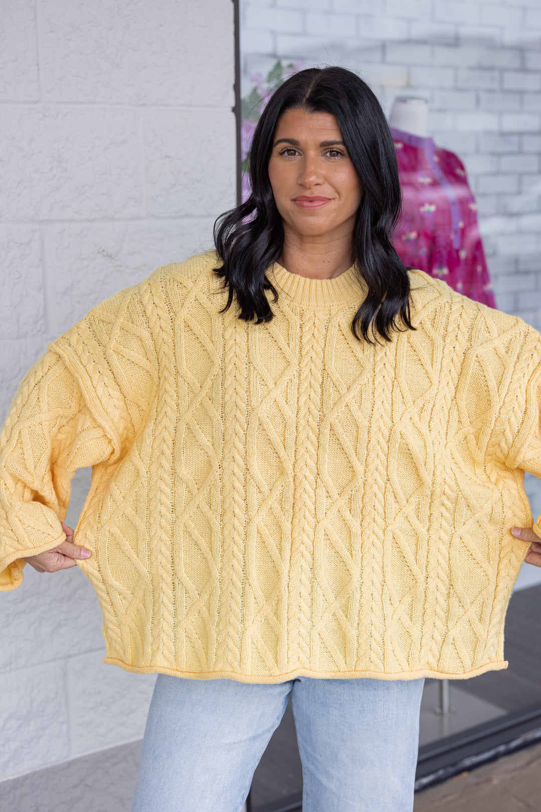 Women's yellow cable knit sweater by GeeGee showing relaxed, boxy fit