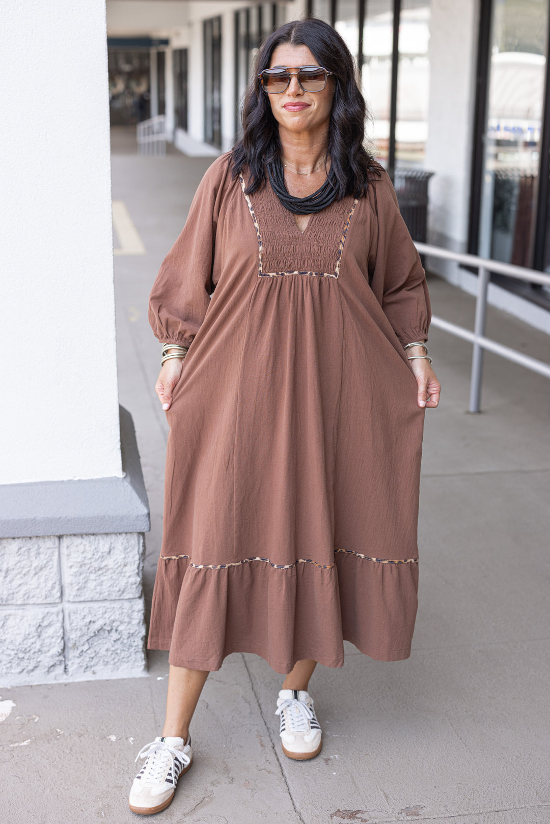 Women's brown midi dress with smocked bodice and leopard print trim by Umgee showing loose silouhette