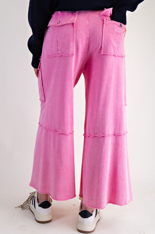 Mineral washed bubblegum pink terry knit cargo pants by Easel showing back view
