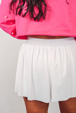 white flowy athletic drawstring shorts