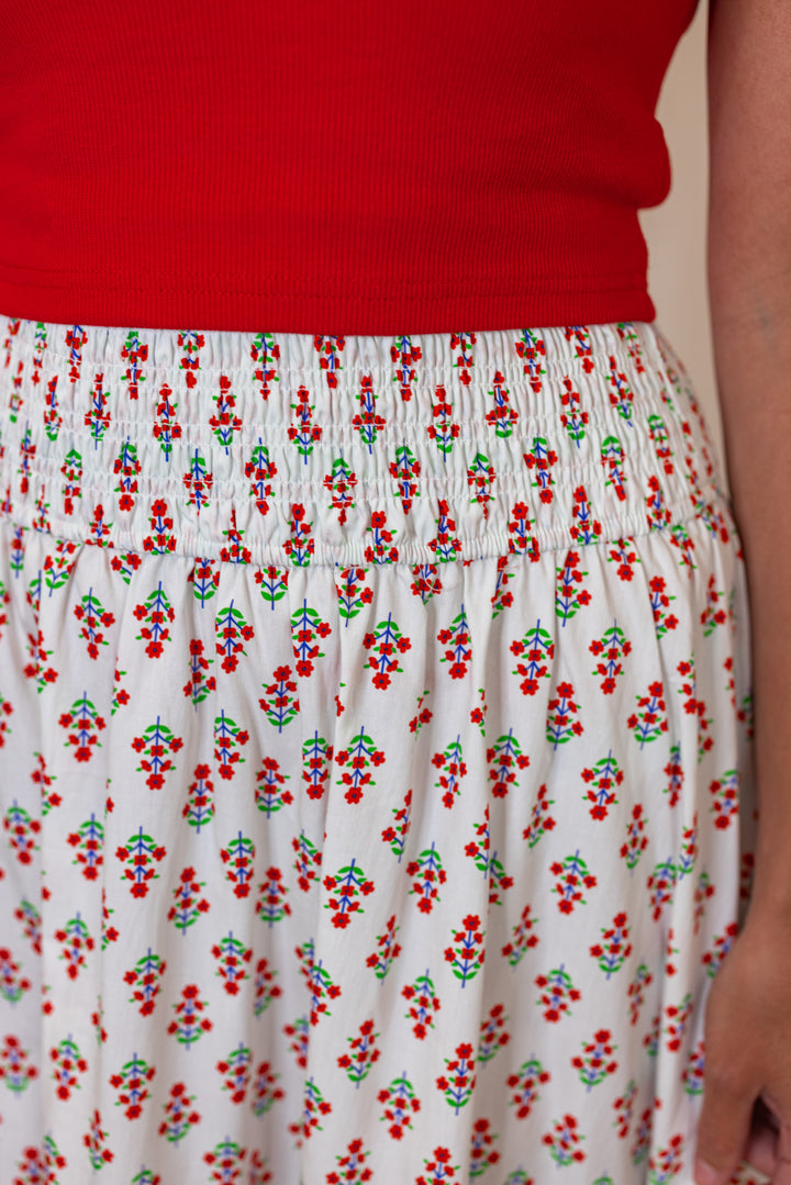 Women's smocked ivory and red floral print tiered poplin maxi skirt by Karlie showing up close front view
