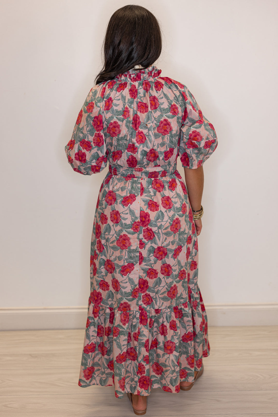 Women's pink and green floral maxi dress with puff sleeves and ruffle detail by Entro showing full back view