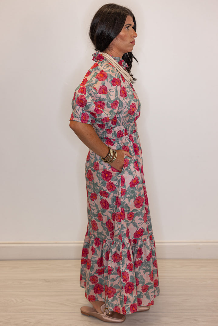 Women's pink and green floral maxi dress with puff sleeves and ruffle detail by Entro showing full side view