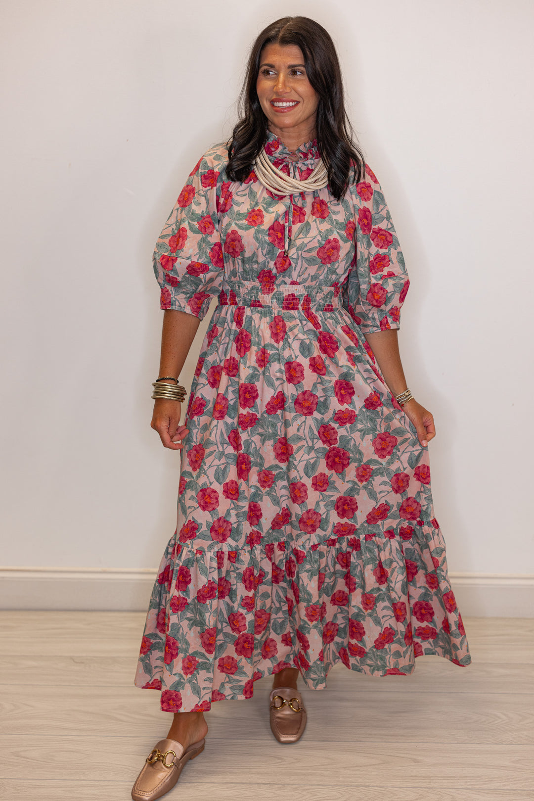 Women's pink and green floral maxi dress with puff sleeves by Entro showing ruffle detail on skirt