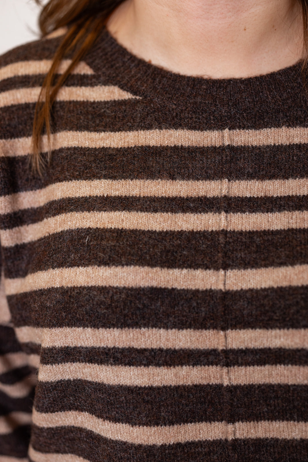 Women's brown and mocha striped sweater knit top by Blu Pepper showing up close view of front seam detail