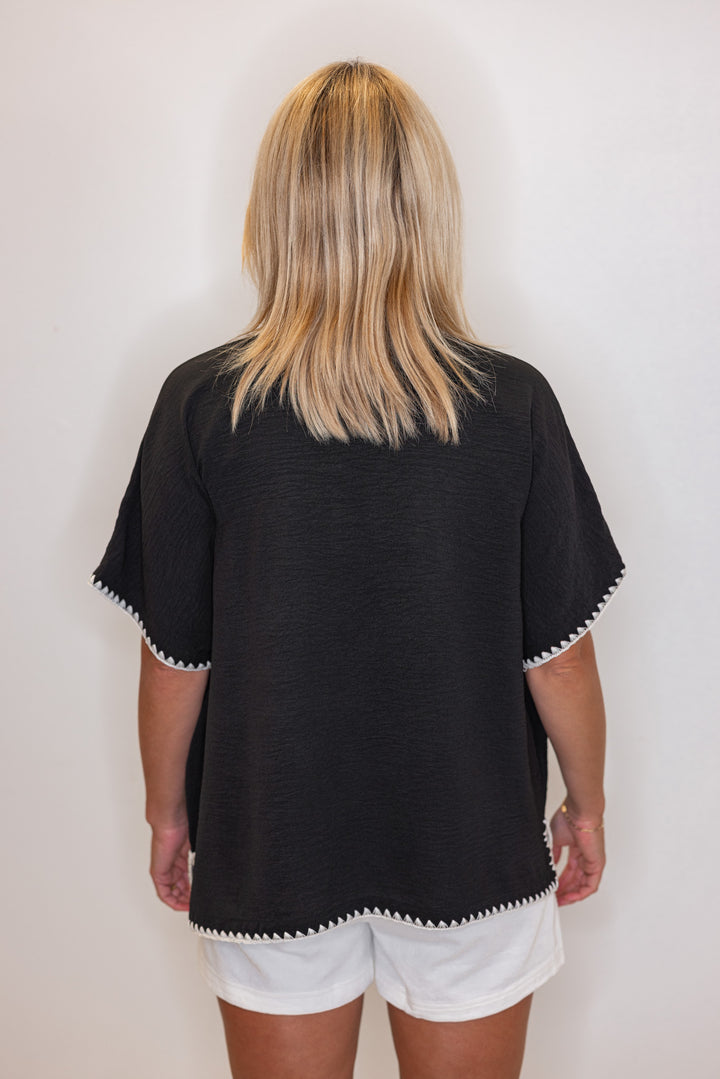 Black lightweight crinkle top with embroidery stitching trim by Jodifl showing back view