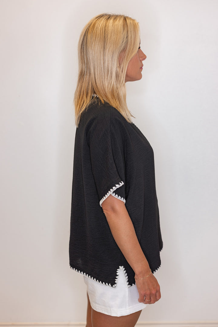 Black lightweight crinkle top with embroidery stitching trim by Jodifl showing side view