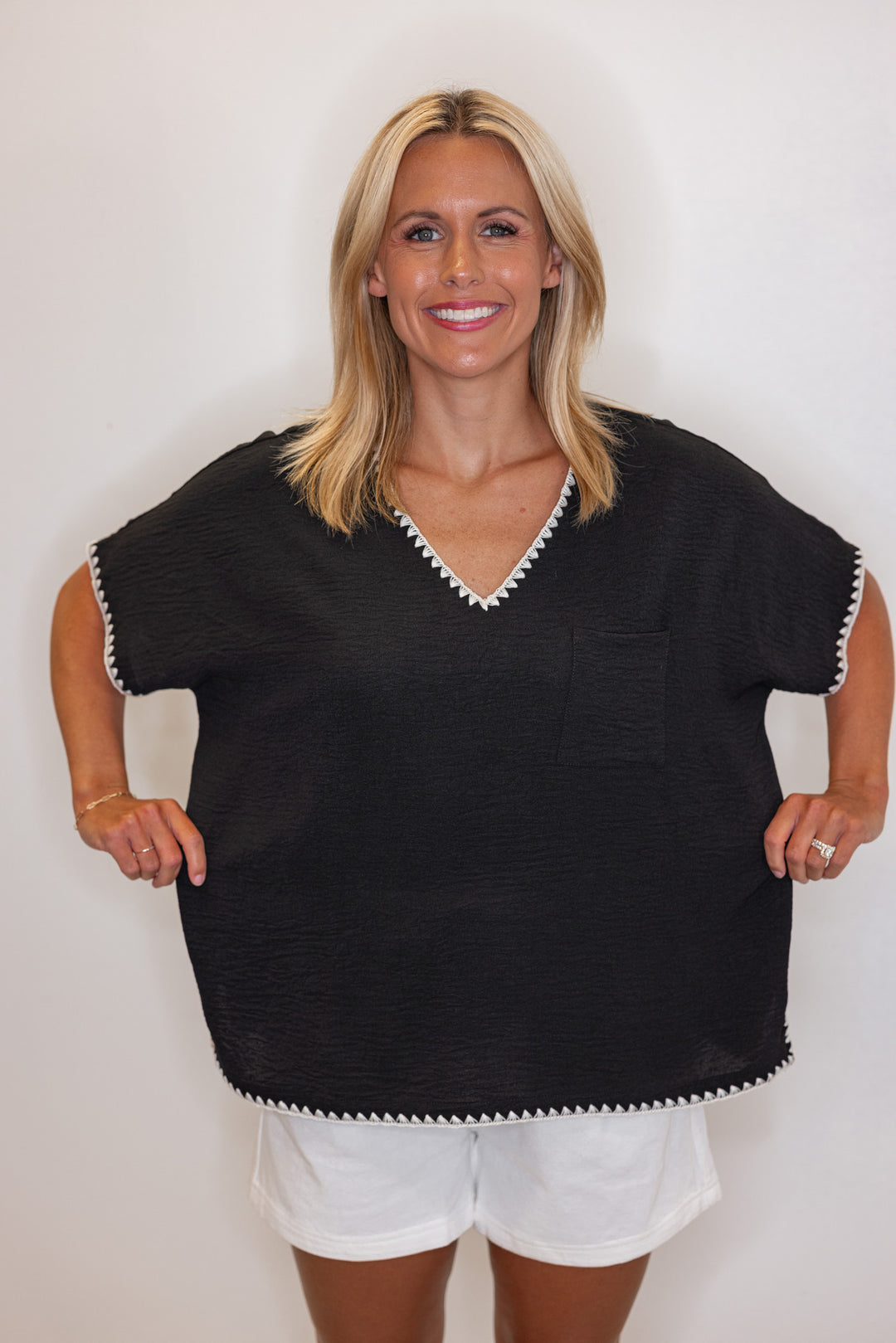 Black lightweight crinkle top with embroidery stitching trim by Jodifl showing relaxed fit