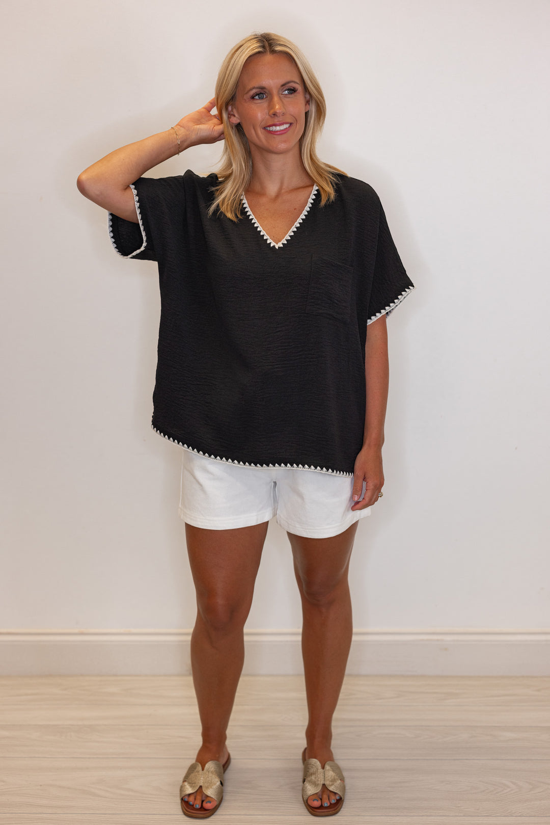 Black lightweight crinkle top with embroidery stitching trim by Jodifl showing full front view
