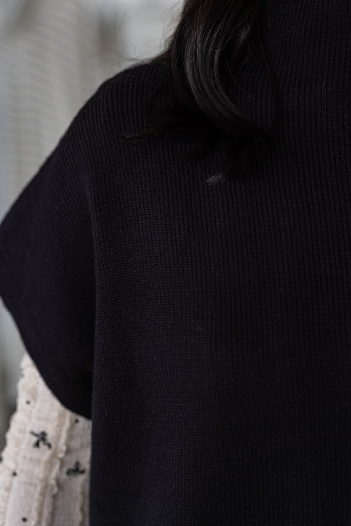 Women's black ribbed knit short dolman sleeve mock neck top by Jodifl showing short dolman sleeves