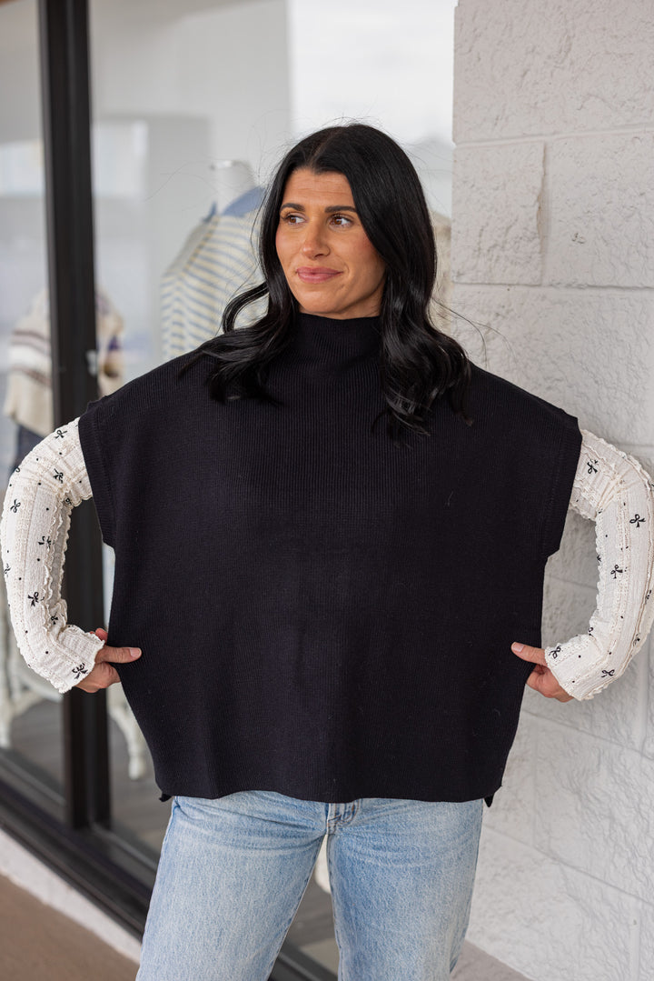 Women's black ribbed knit short dolman sleeve mock neck top by Jodifl showing relaxed, boxy fit