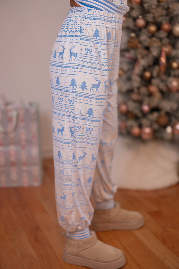 Women's white and light blue Christmas Winter print fleece pajama jogger pants by Peach Love California showing up close side view