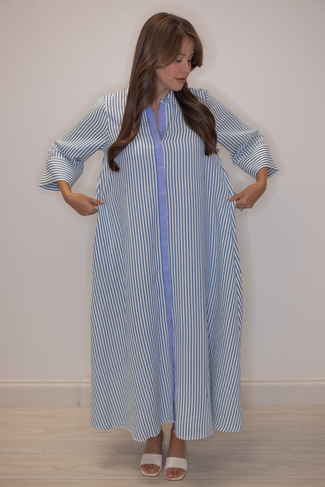 Women's striped blue maxi dress by Entro showing flowy skirt