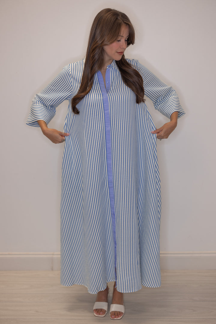 Women's striped blue maxi dress by Entro showing flowy skirt