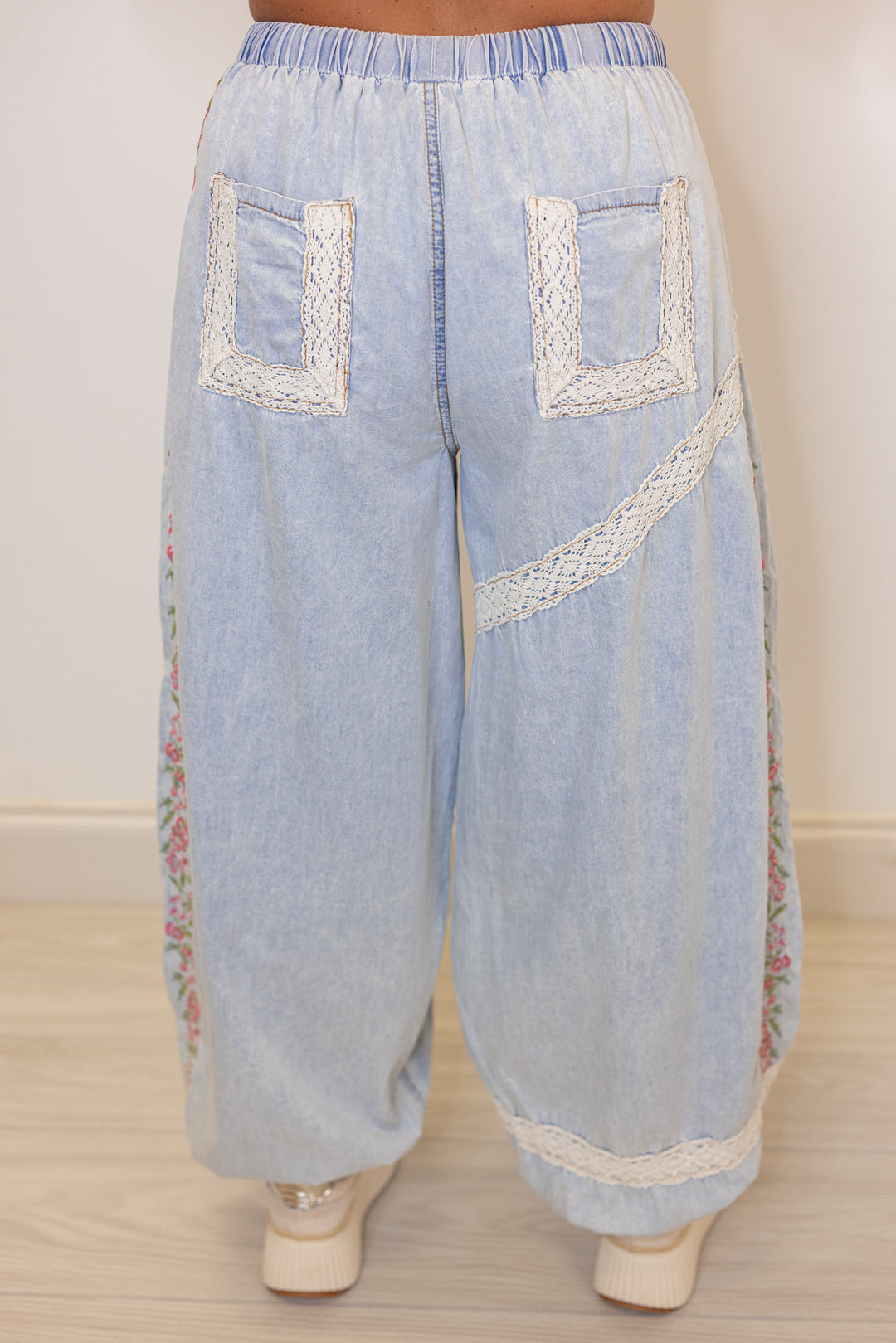 Women's wide leg jogger pants with pink floral embroidery trim and lace details by POL showing up close back view