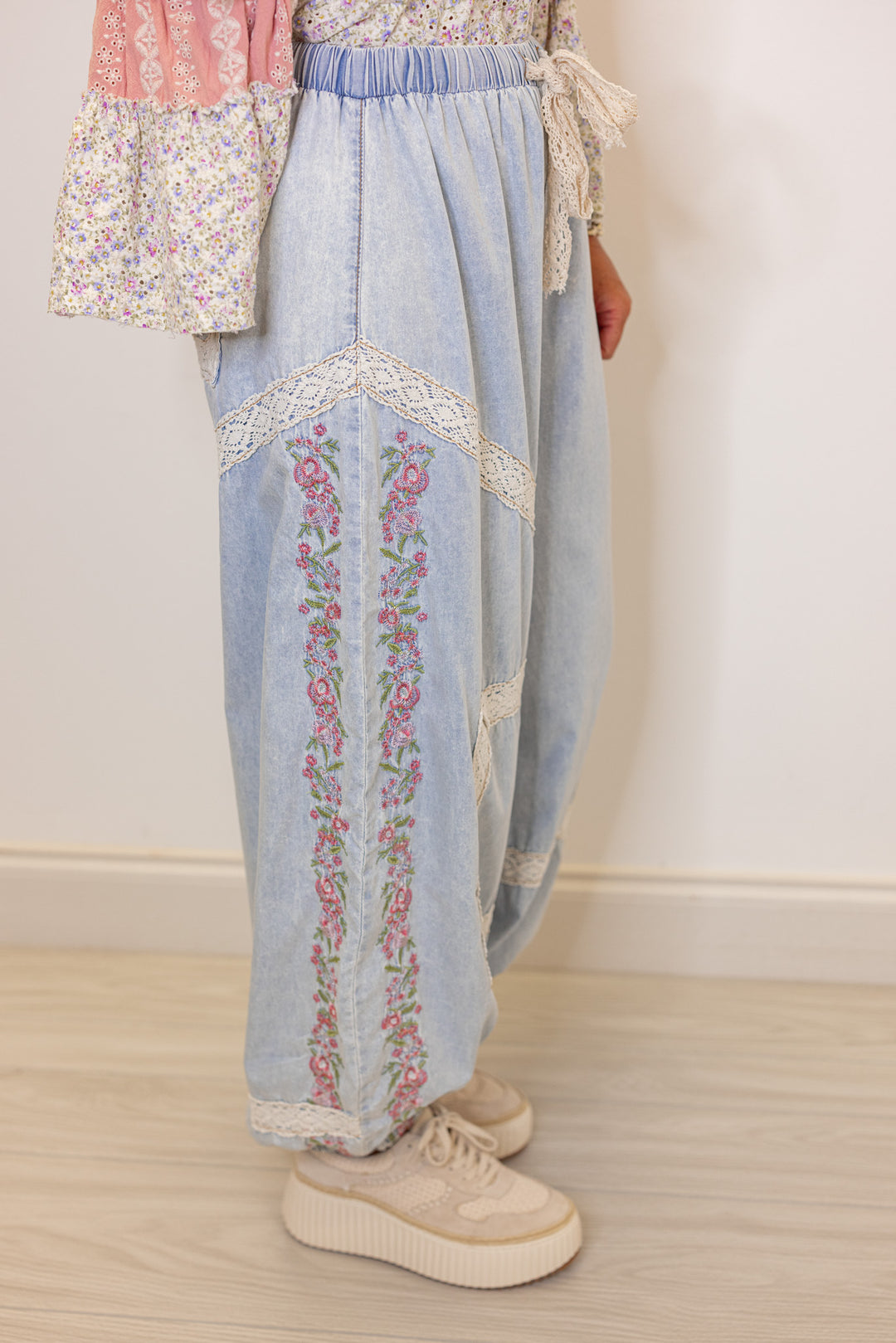 Women's wide leg jogger pants with pink floral embroidery trim and lace details by POL showing side view
