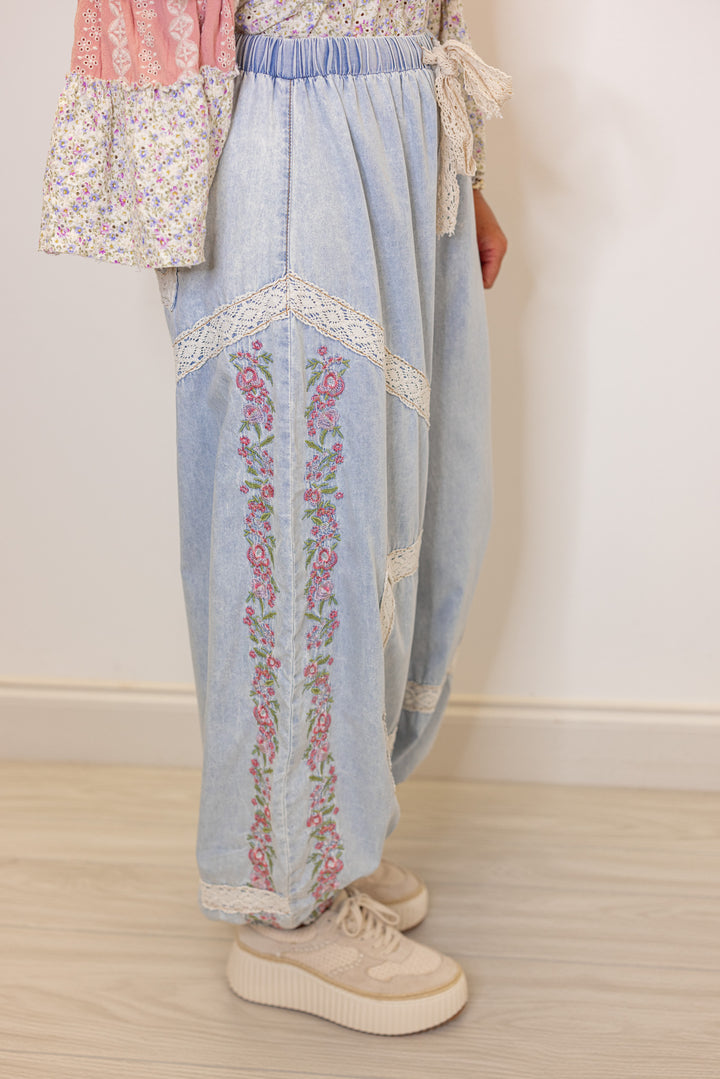 Women's wide leg jogger pants with pink floral embroidery trim and lace details by POL showing side view