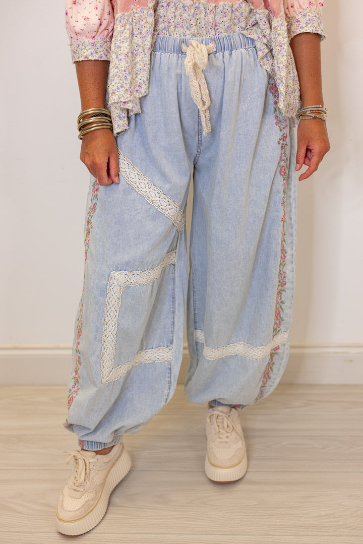 Women's wide leg jogger pants with pink floral embroidery trim and lace details by POL