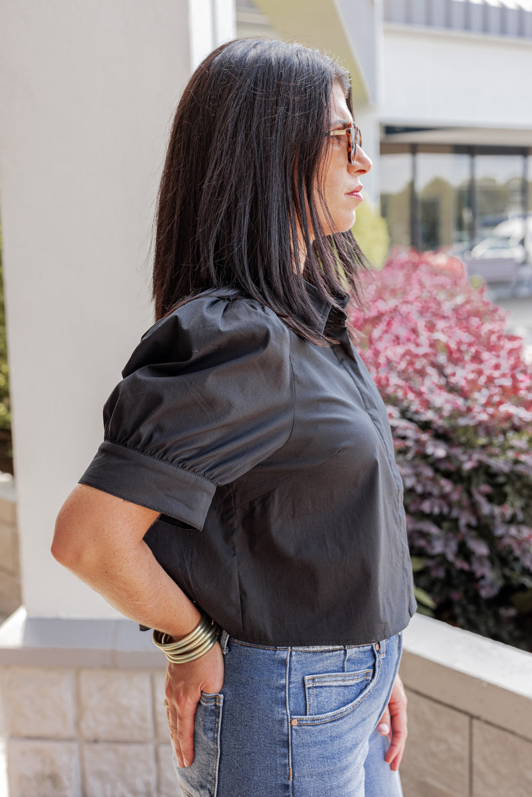 Women's black puff sleeve button front cropped top by Entro showing up close side view