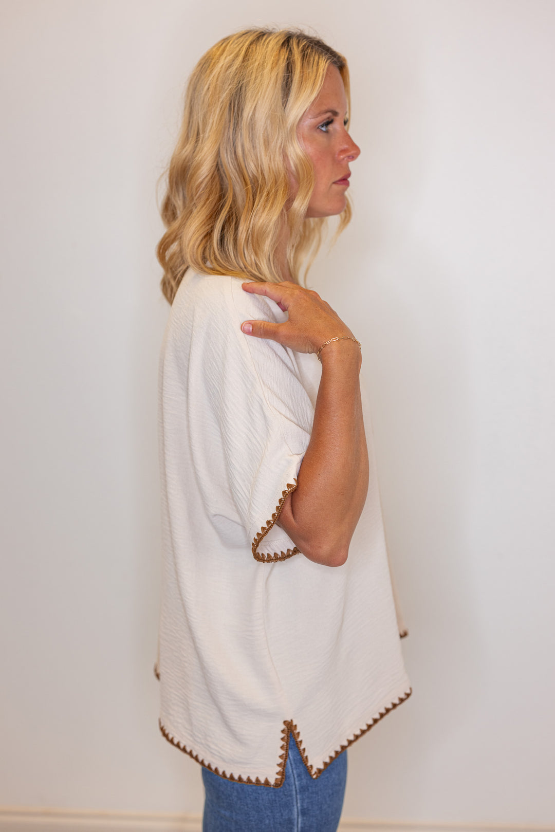 Oatmeal lightweight crinkle top with embroidery stitching trim by Jodifl showing side view