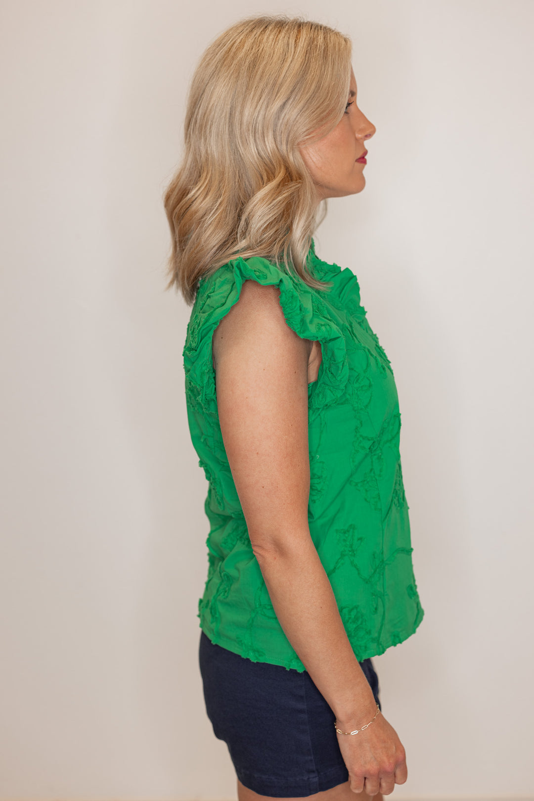 Women's green button top with green floral appliques throughout by Entro showing side view