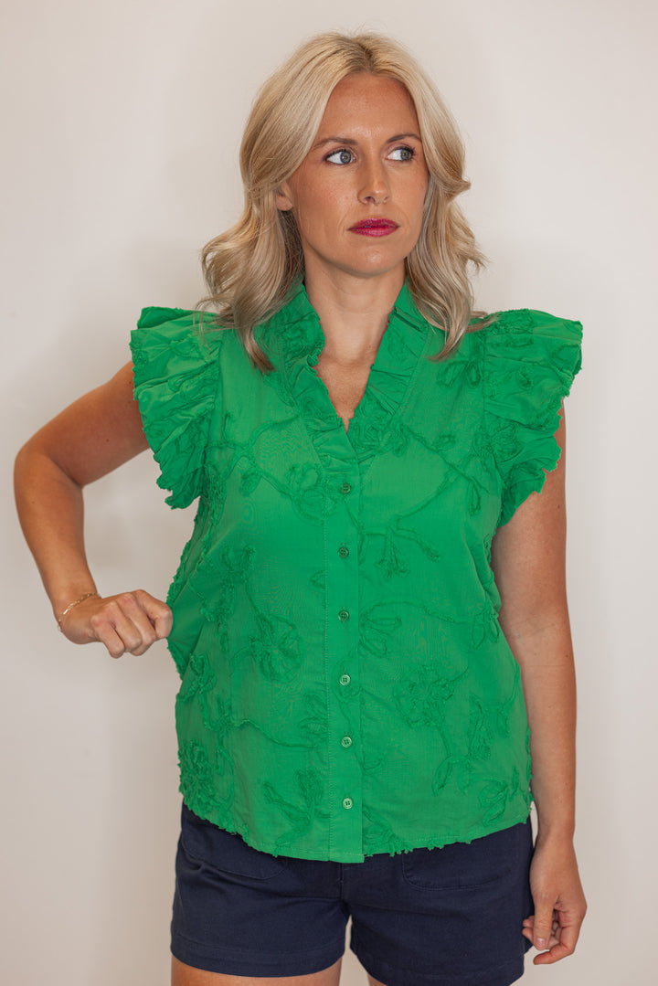 Women's green button top with green floral appliques throughout by Entro showing width of shirt's material
